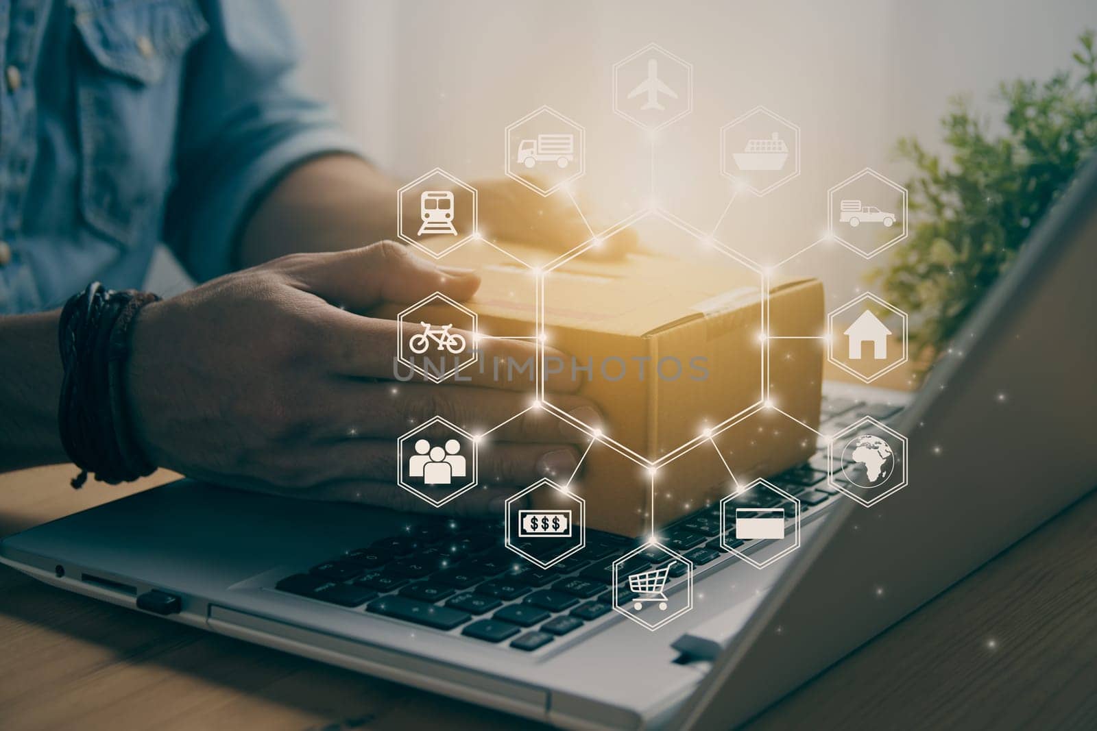 Hand of Casual Businessman or Entrepreneur Catch Parcel or Box on Laptop and Hexagonal Logistic or Transportation Icon. SME Online Business and E-commerce Concept for Work at Home in Vintage Tone
