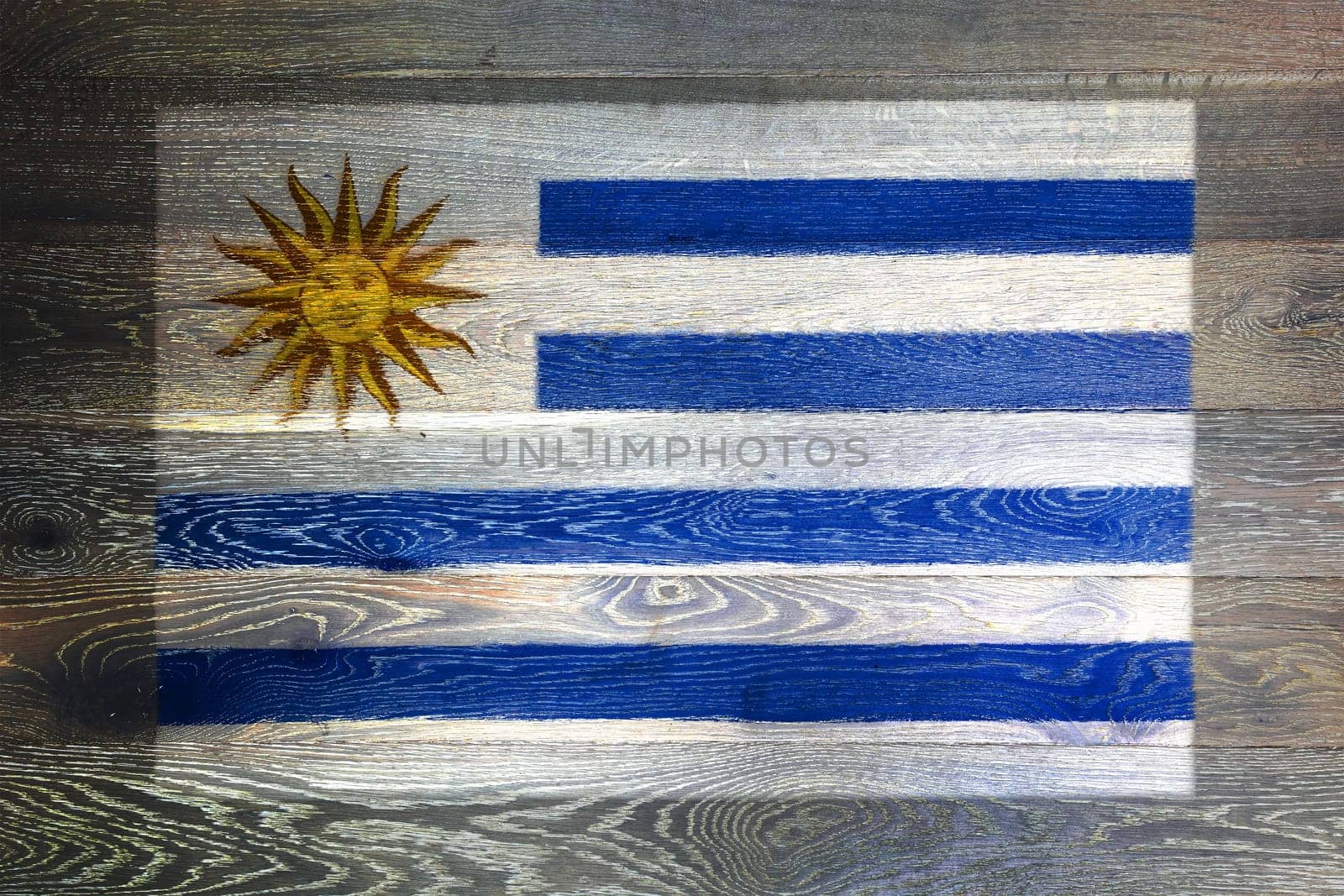 A Uruguay flag on rustic old wood surface background blue white stripes Sun of May