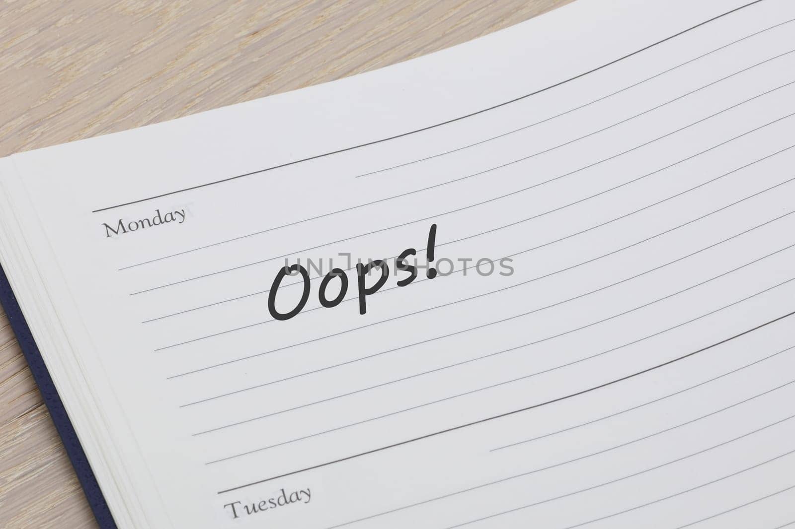 An oops diary reminder appointment open on desk