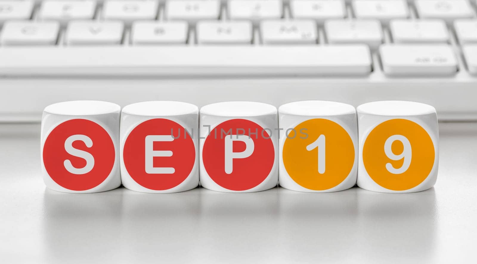 Letter dice in front of a keyboard - September 19