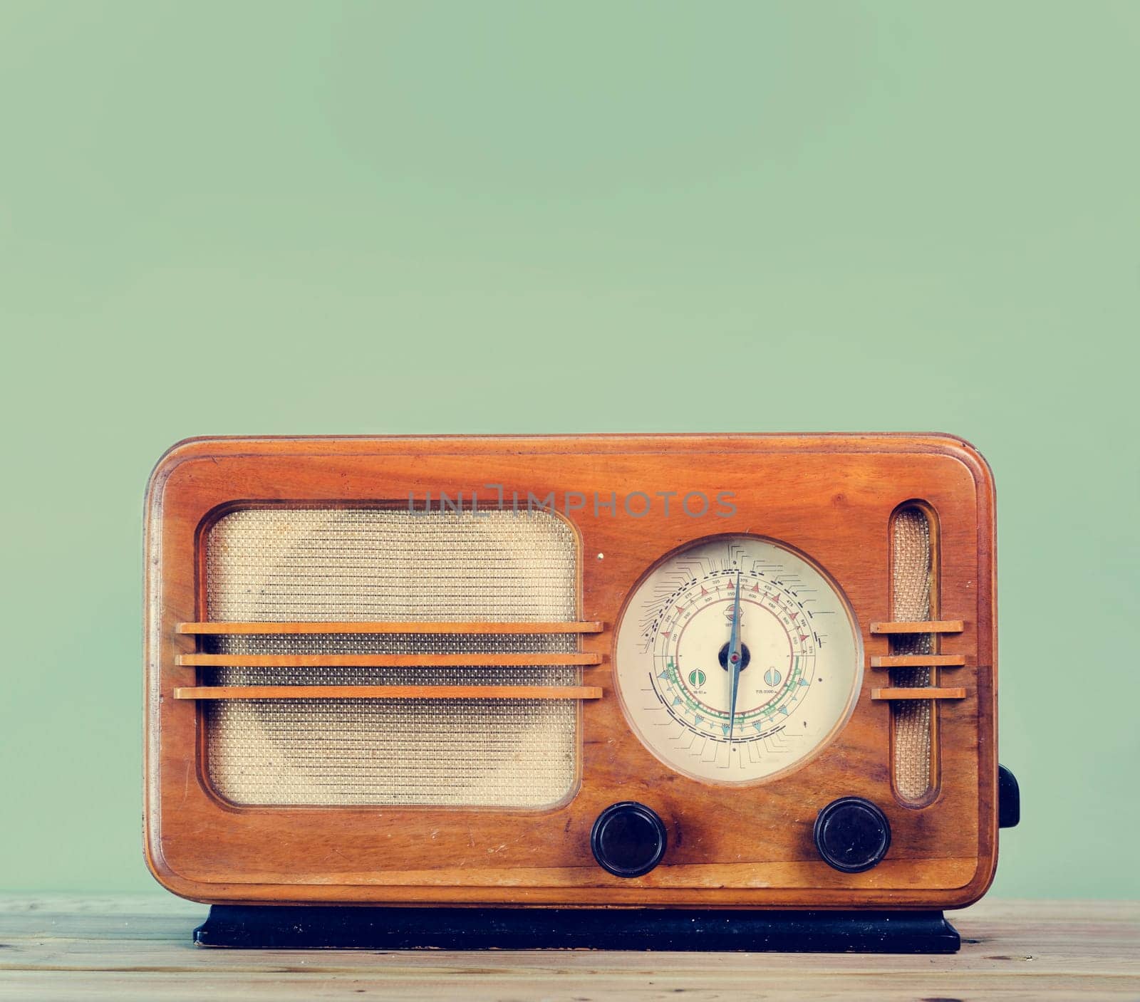 Old style vintage radio over retro mint background with copyspace design.