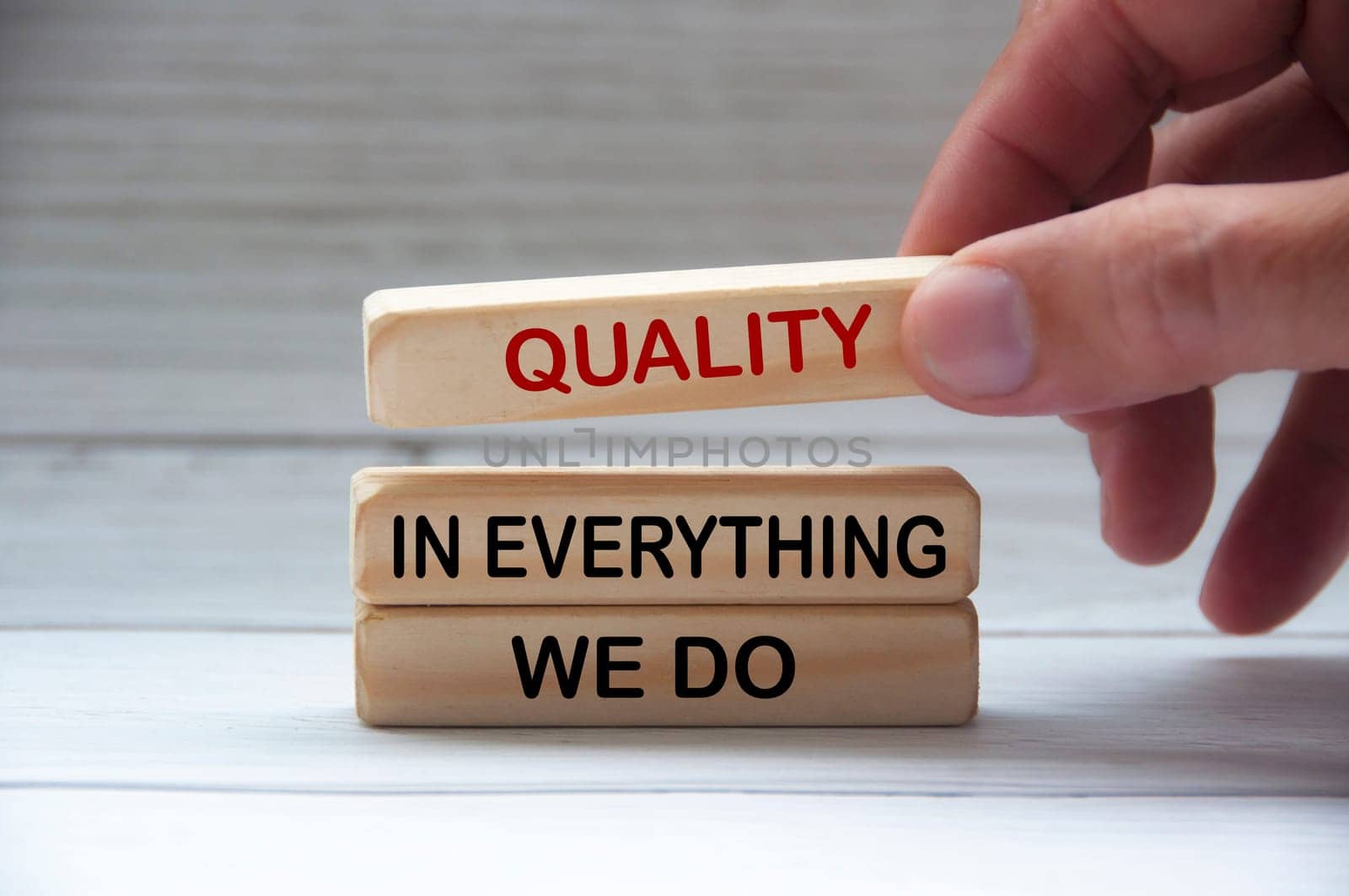 Quality in everything we do text on wooden blocks. Quality control and business concept