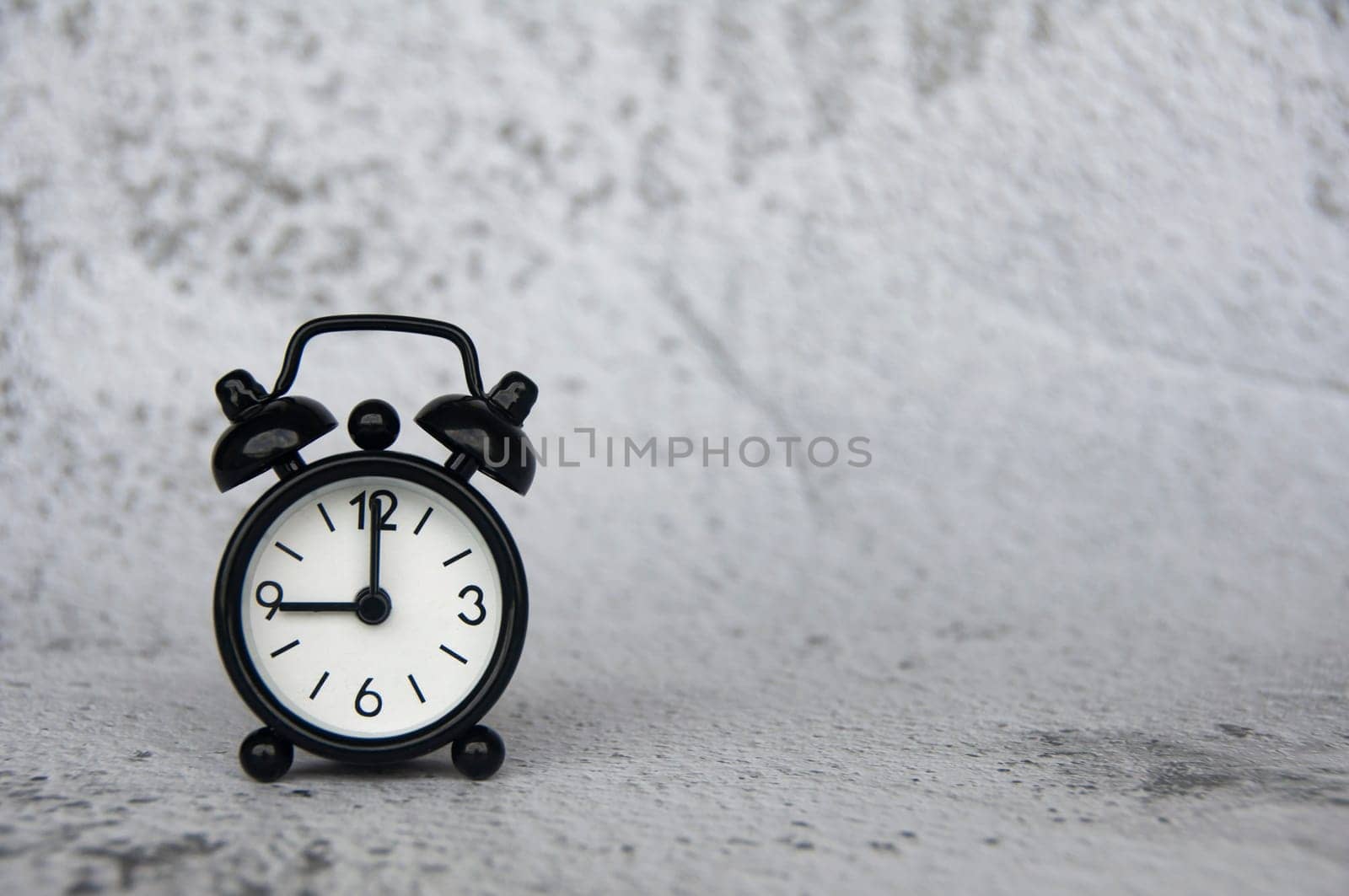 Alarm clock pointing at 9 o'clock with customizable space for ideas or text. Copy space and time concept