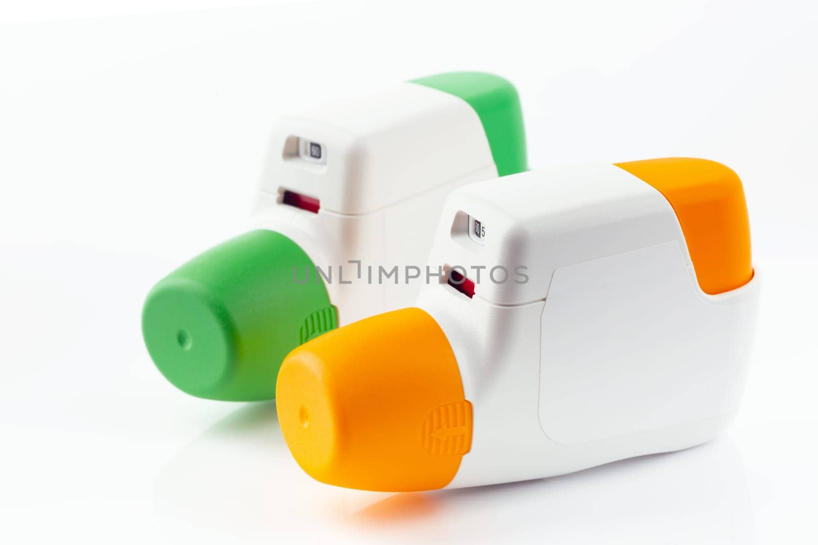 Two Metered Dose Inhaler isolated over white background