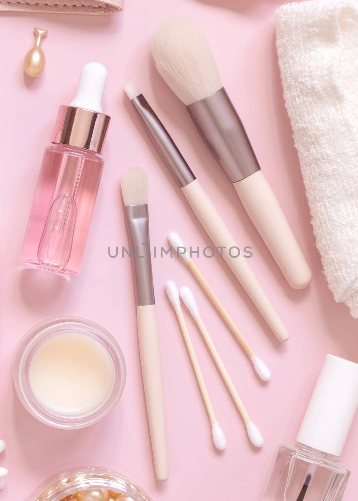 Skin care and make up brushes on light pink, top view. Flat lay with natural beauty products and decorative cosmetics. Everyday woman face care routine. Pastel composition