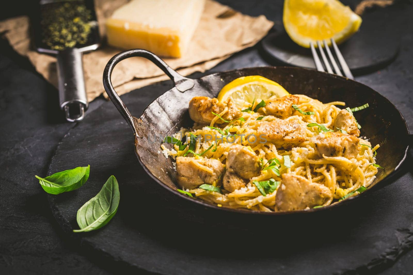 Lemon Chicken Pasta in cast iron pan with basil and Parmesan.