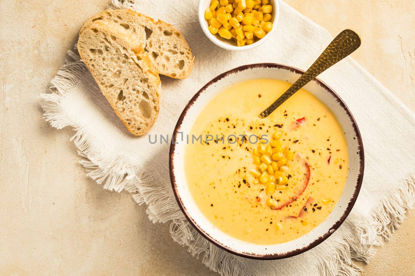 Delicious creamy chilli cheese corn soup served with bread