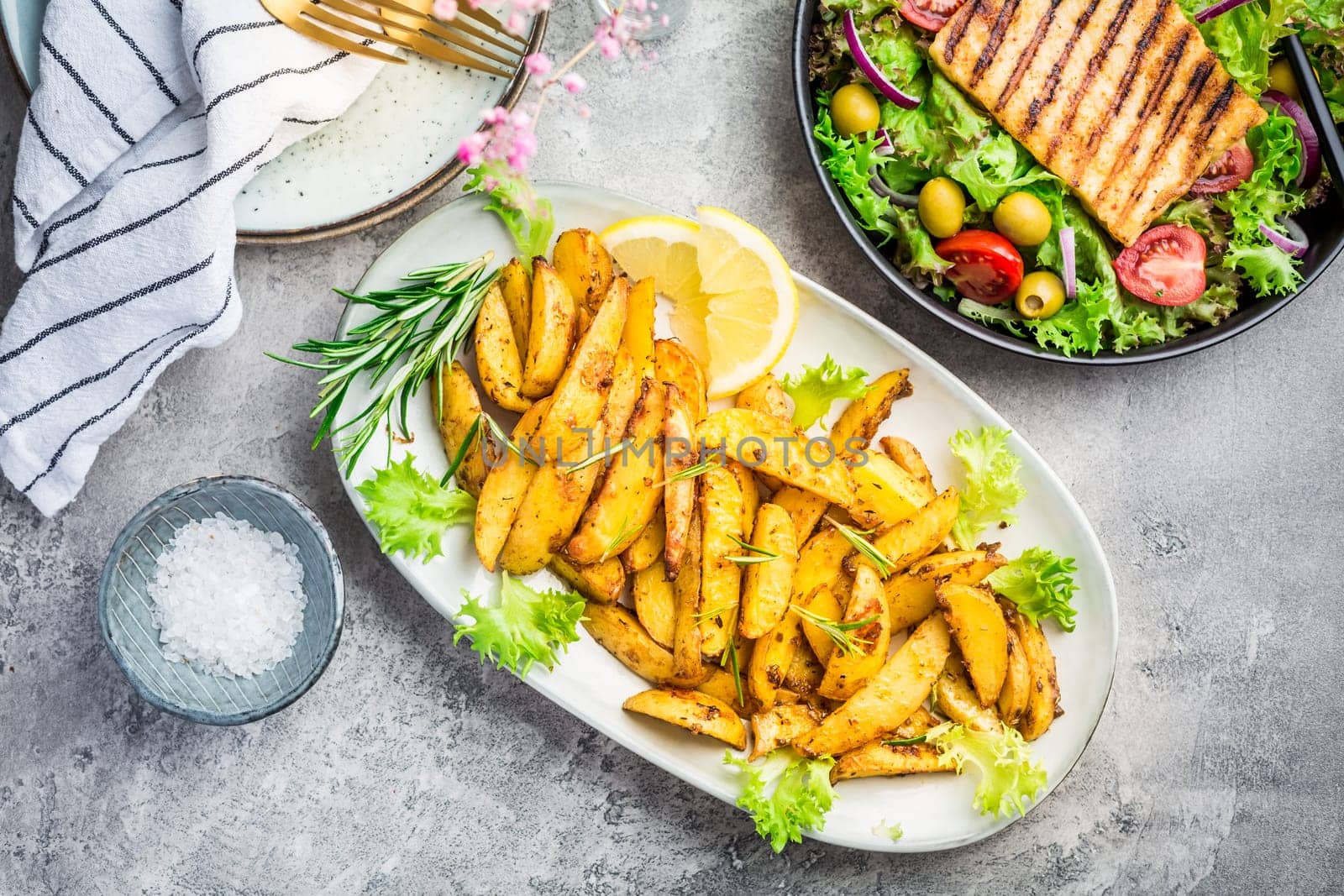 Potato wedges, oven roasted with freshly mixed salad and grilled cheese