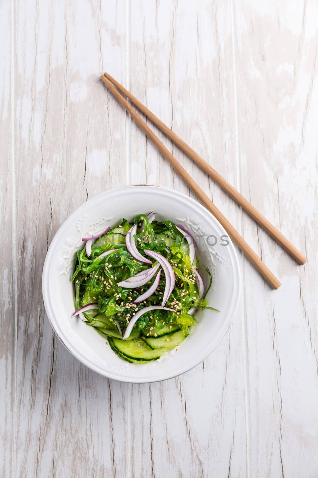 Traditional Japanese Sunomono salad with cucumber and wakame seaweed and sesame seeds
