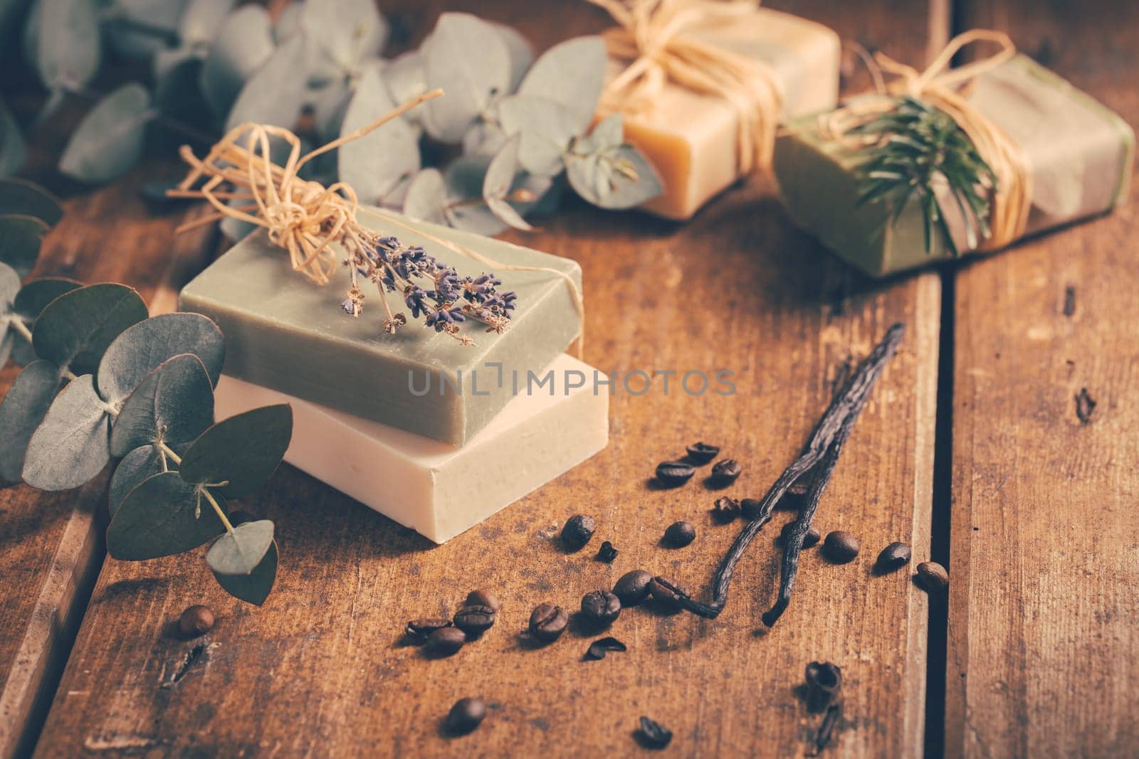 Natural organic soap bars with vanilla, coffee beans and eucalyptus on wooden background
