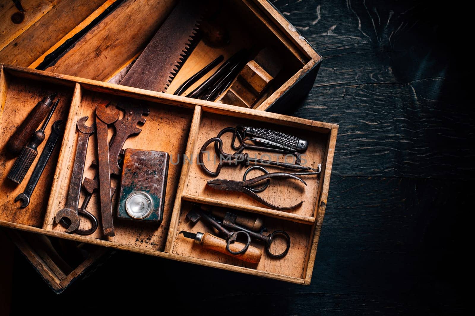 Collection of vintage carpentry tools in old wooden chest: woodworking, craftsmanship and handwork concept