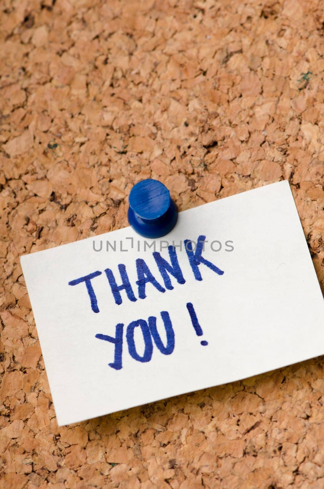 Thank you message on sticker note pin on cork office board. Business concept.
