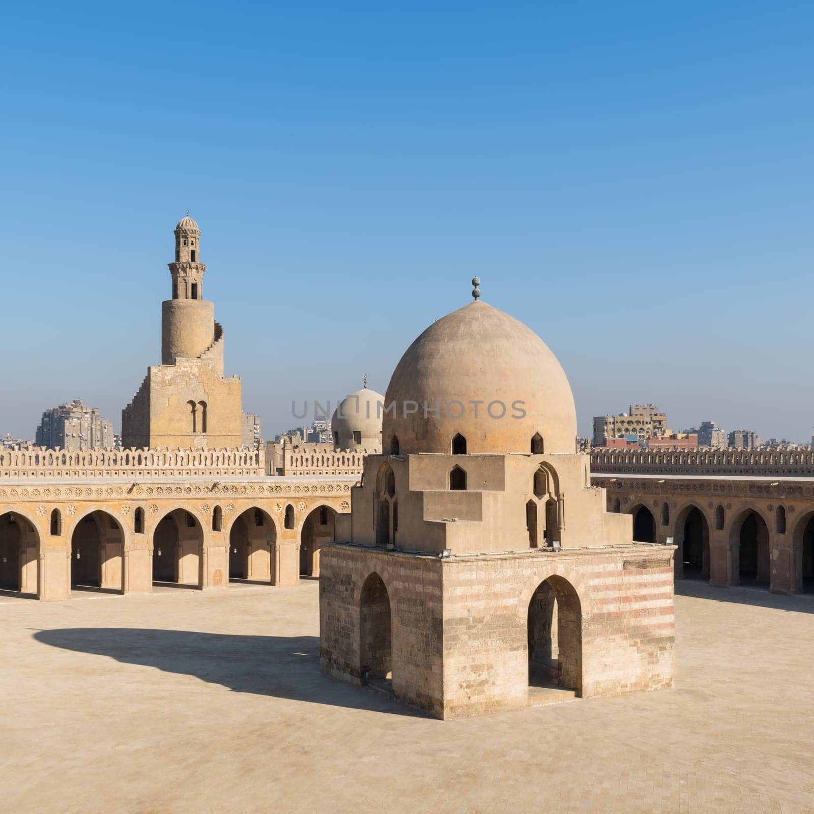 Courtyard of Ibn Tulun public historical mosque with ablution fountain and the minaret, Sayyida Zaynab district, Medieval Cairo, Egypt