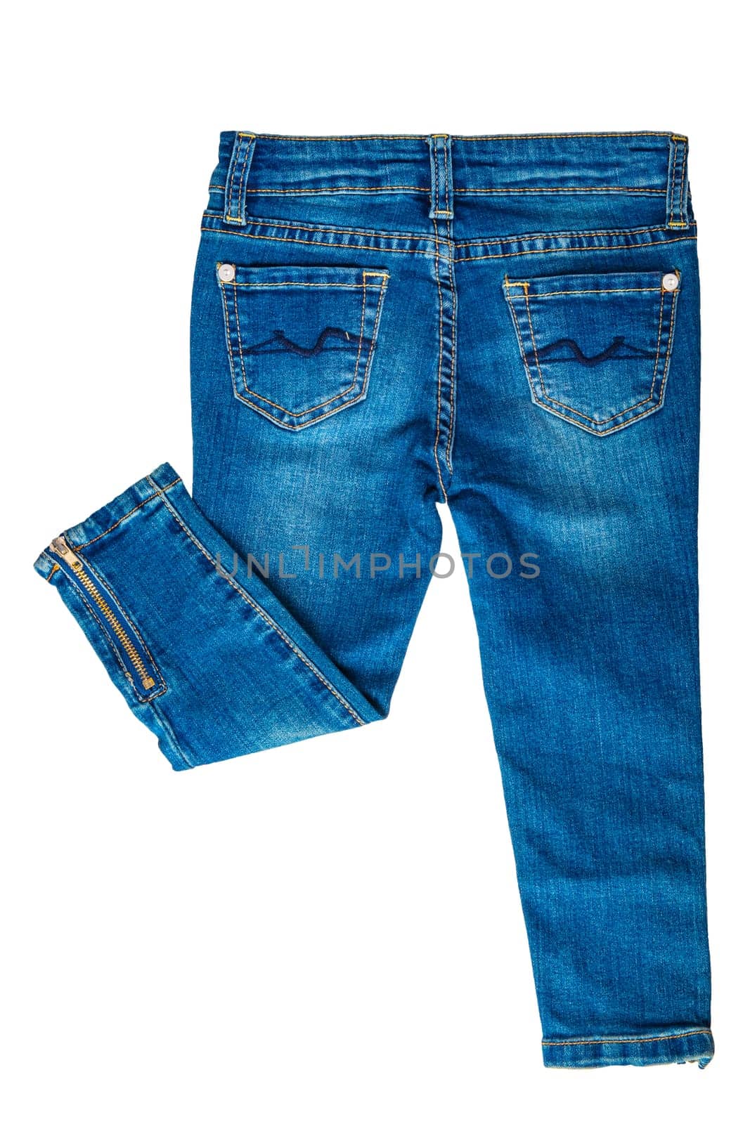 Girls jeans isolated. Folded trendy stylish female blue jeans trousers isolated on a white background. Fashionable denim pants for kids. Back view.