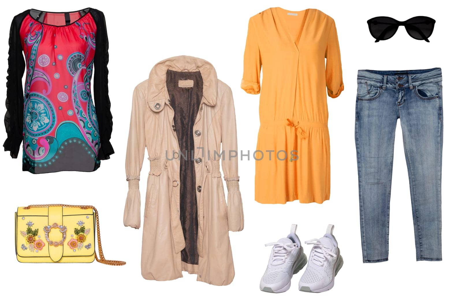 Collage woman clothes. Set of a stylish and trendy women coat, a blouse or shirt, white shoes, a handbag, a jeans and other accessories isolated on a white background. Latest fashion trends.