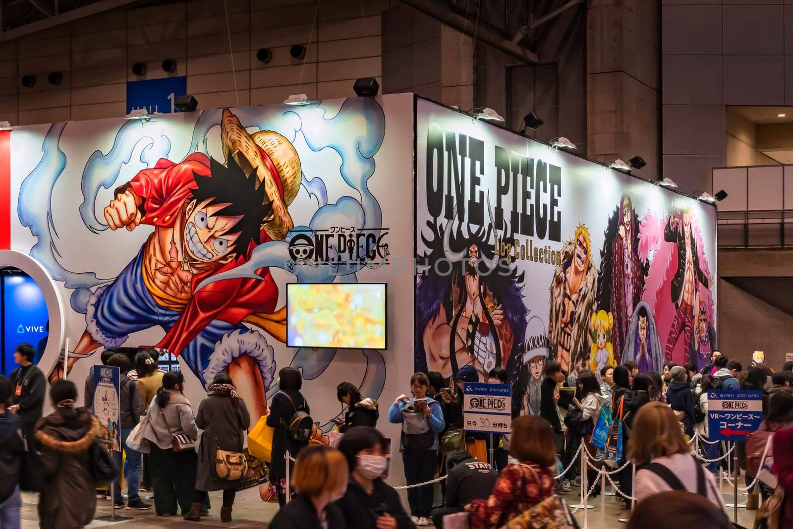chiba, japan - december 22 2018: Crowd of people queuing along the  area dedicating to the manga One Piece decorated with the character of Monkey D. Luffy during the anime convention Jump Festa 19.