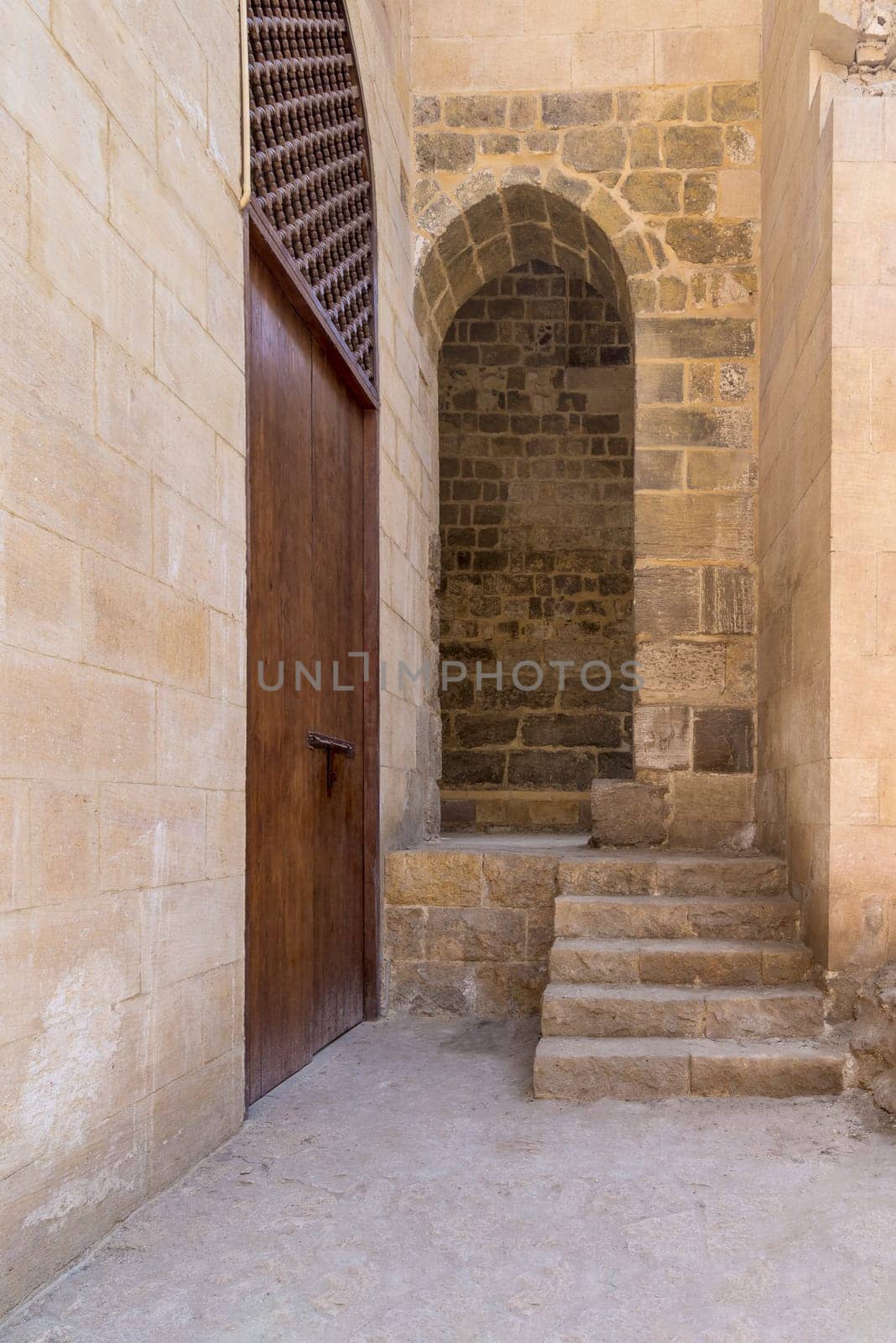 Stone staircase leading to vaulted entrance at stone bricks wall, Medieval Cairo, Egypt