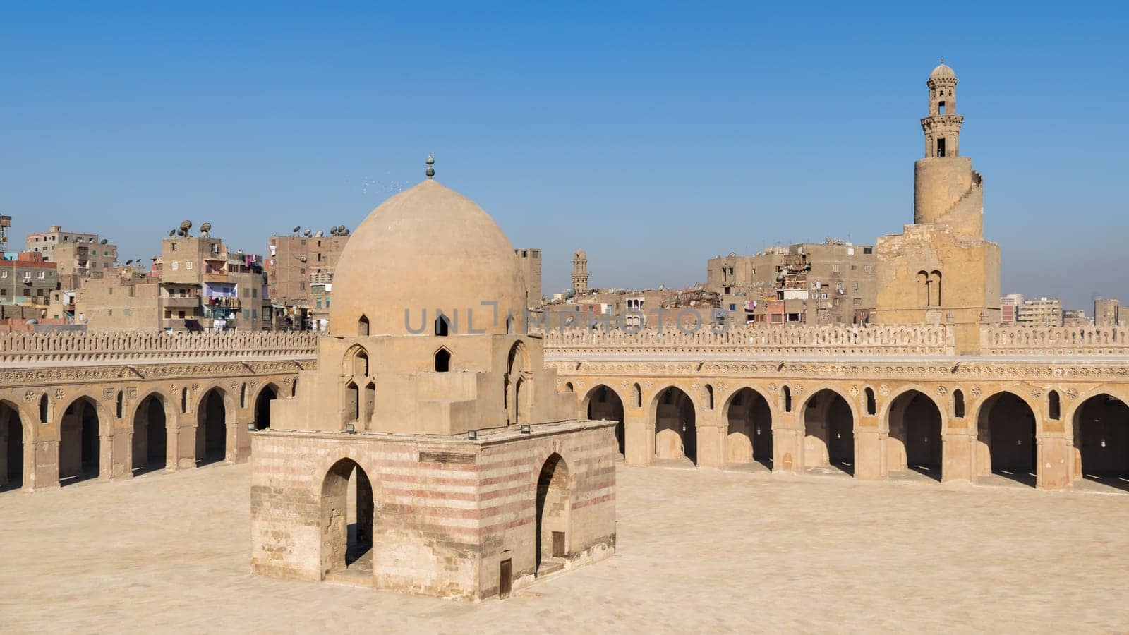 Courtyard of Ibn Tulun public historical mosque with ablution fountain and the minaret, Sayyida Zaynab district, Medieval Cairo, Egypt