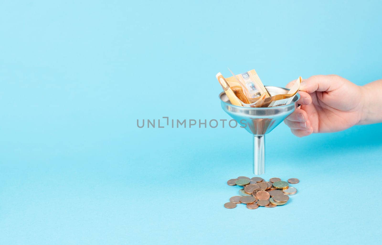 Inflation and financial crash, euro banknotes in a funnel become coins, economic development and increasing prices, worthless money