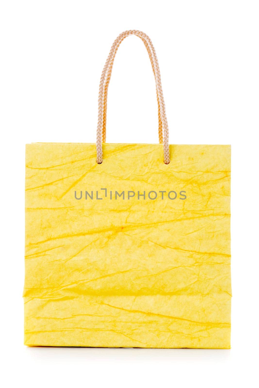 Yellow gift bag made of corrugated paper with raised handles. Consumer pack ready for logo design. Advertising and branding. Isolated on a white background.