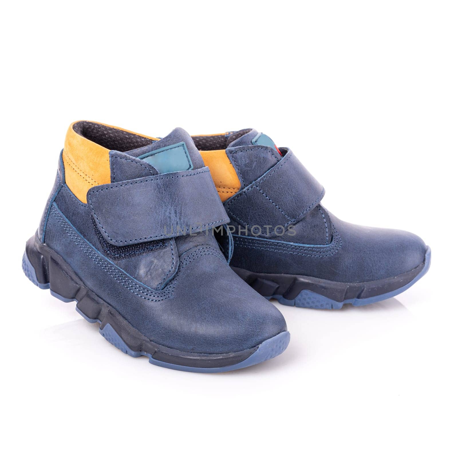 Close up of fashionable blue autumn velcro shoes for toddlers boys. Sports style. Children's fashion and style concept. Isolated on white background.