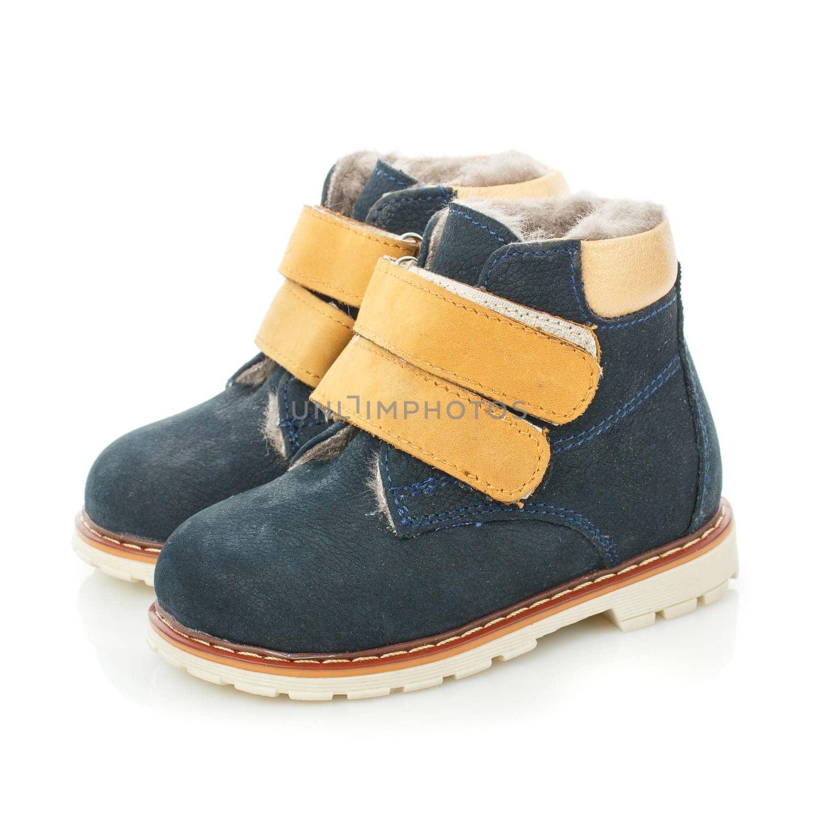 Close up of a pair of new modern dark green stylish shoes for toddlers on a white background. Warm velcro shoes with fur lining. Banner concept. Copy space