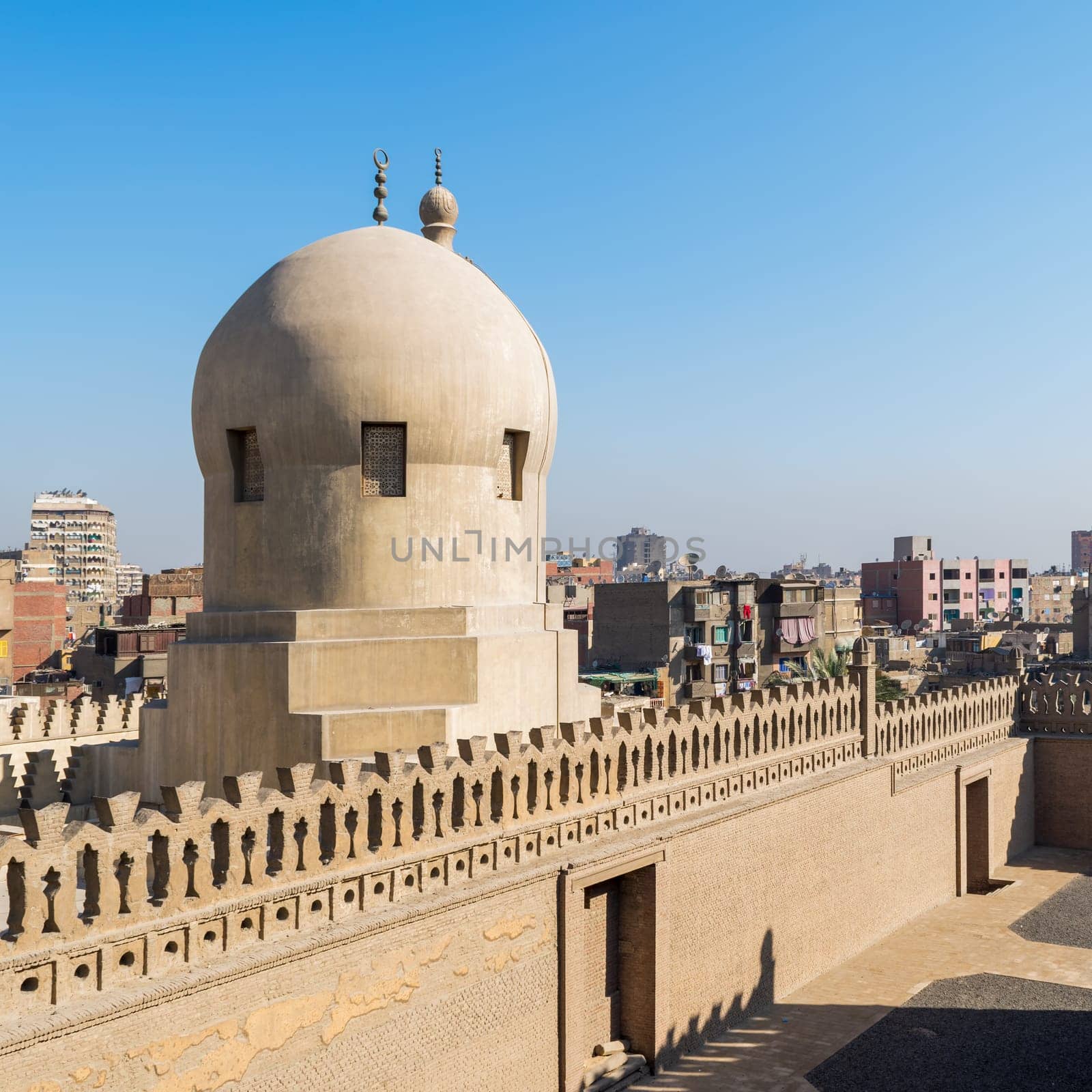 Fence of Ibn Tulun Mosque revealing dome of Amir Sarghatmish mosque, Sayyida Zaynab district, Medieval Cairo, Egypt