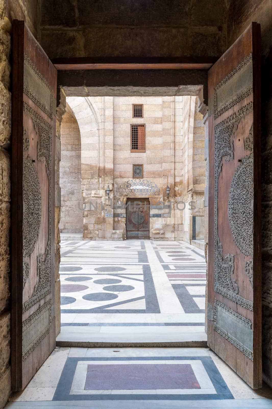 Opened door leading to the courtyard of Al-Sultan Al-Zahir Barquq mosque. Al-Moez Street, Old Cairo, Egypt
