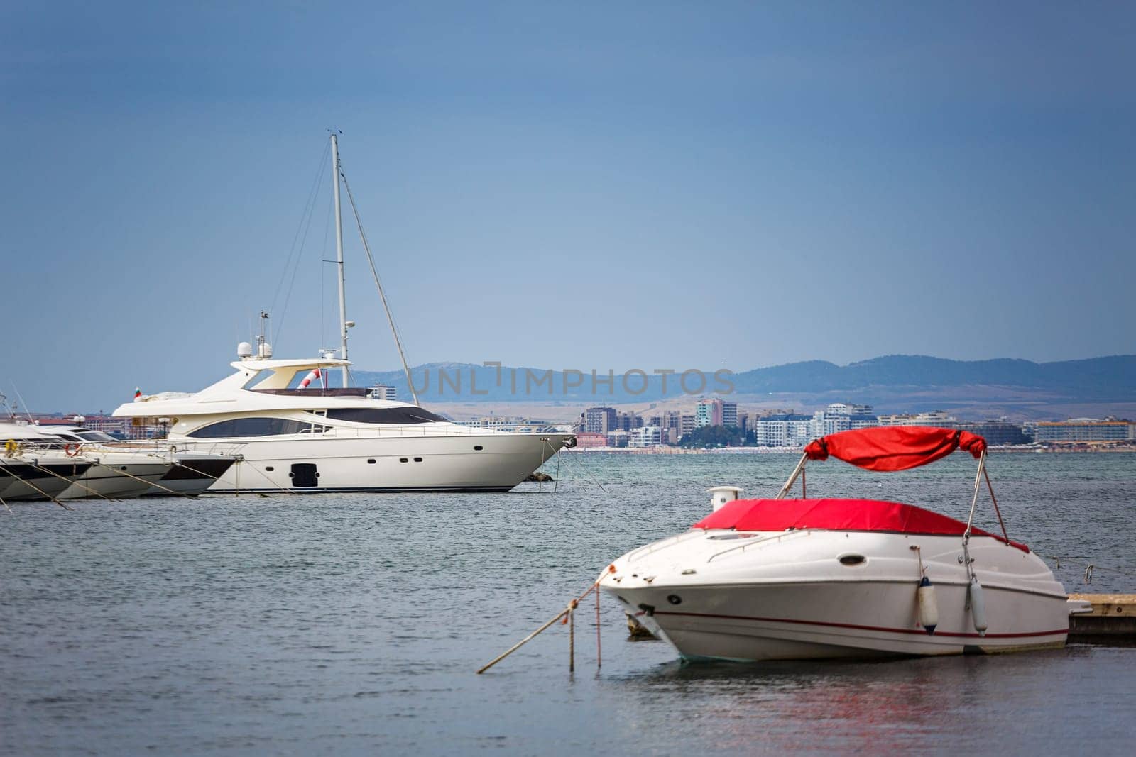 Yachts parked near a pear. Summer seascape. Travel and Vacation Concept. Beautiful sunny day