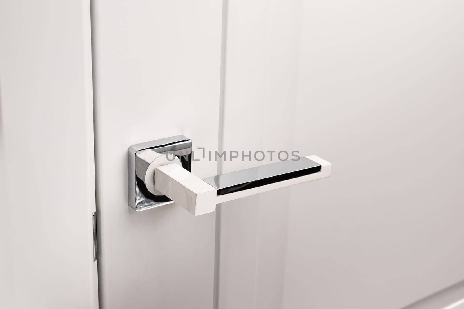 Door handles elements close up. Door handle on white closed doors in modern loft style in interior. Concept of accessories for interior design home interior of apartment or office.