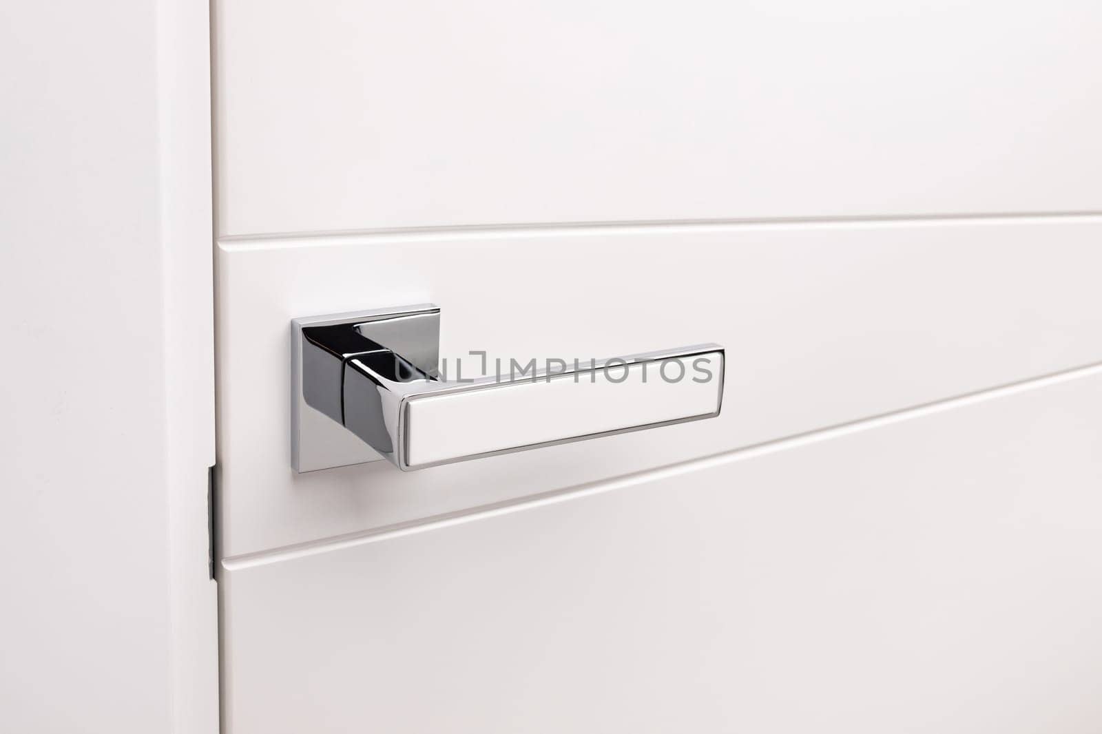 Door handles elements close up. Door handle on white closed doors in modern loft style in interior. Concept of accessories for interior design home interior of apartment or office.