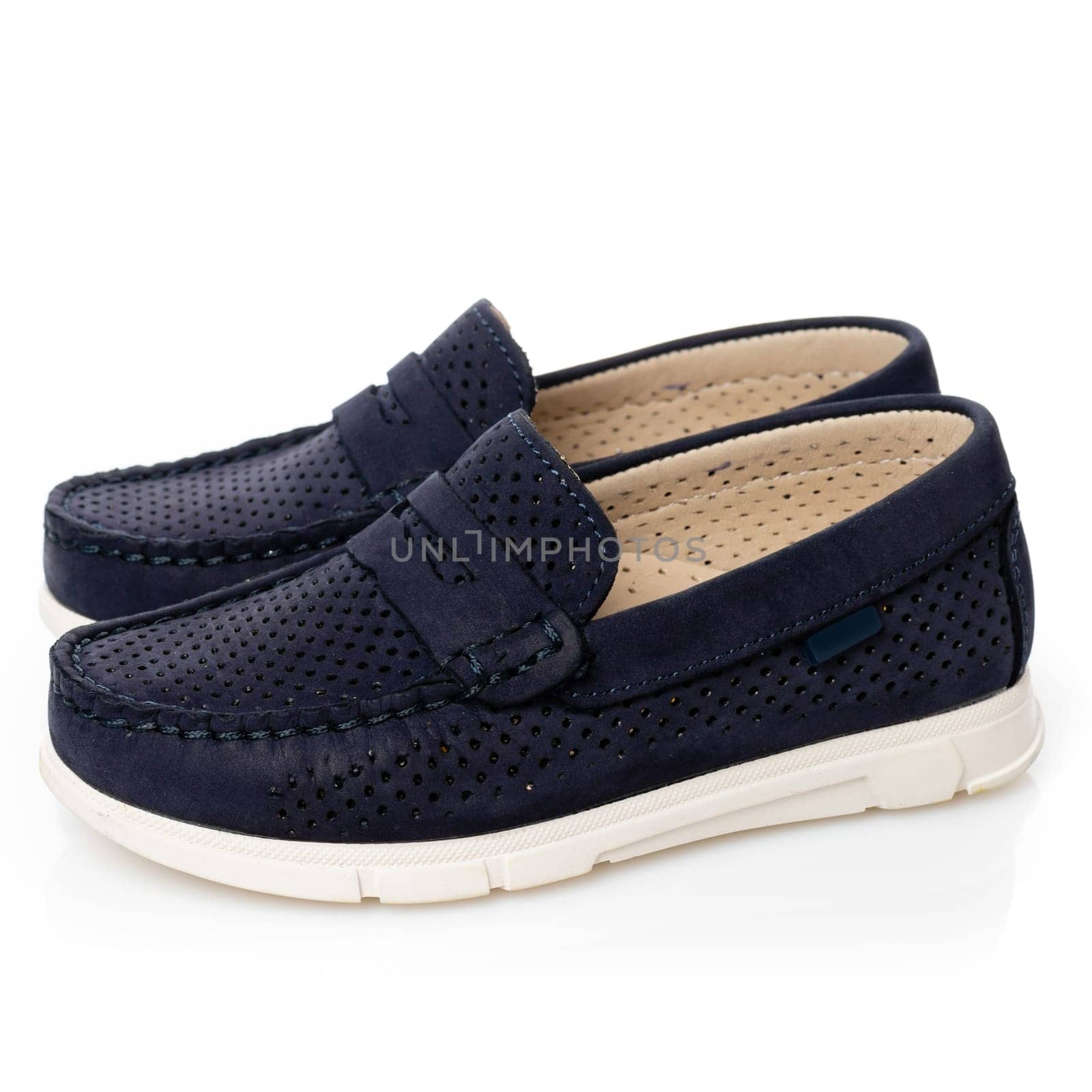 Close up of children's loafers isolated on white background. Side view of blue shoes for boys with white soles. Concept of children's style and sale of children's shoes.