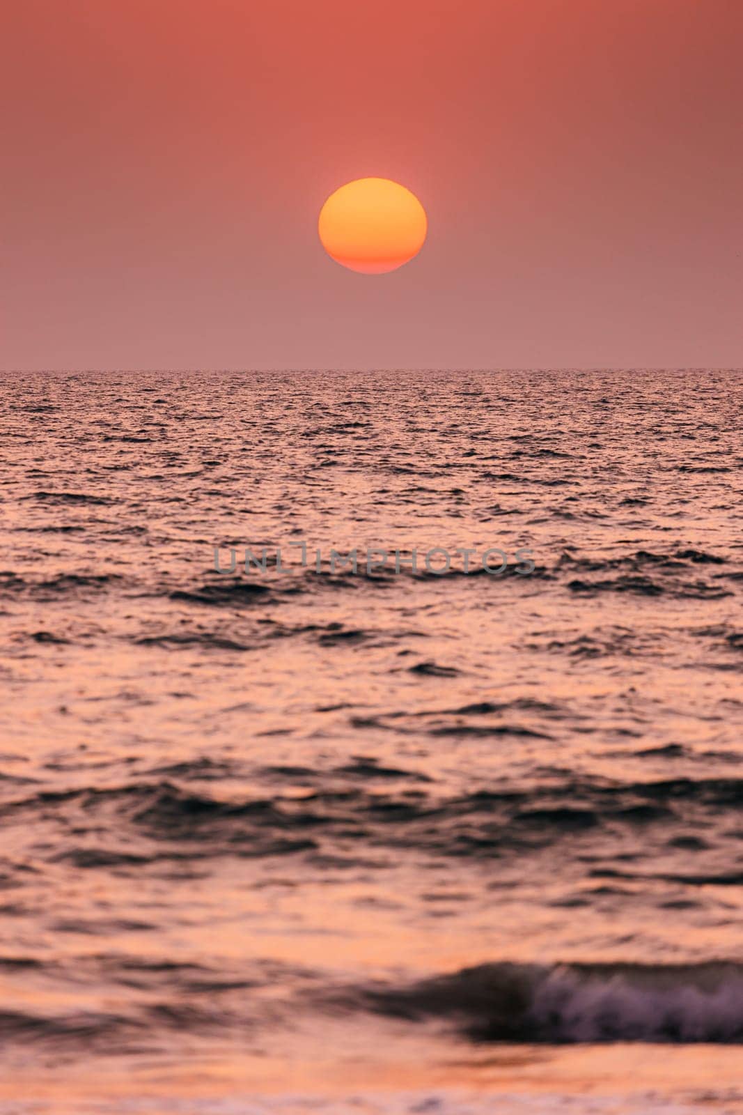 Natural Color Sunset Sunrise Sky Over Sea. Seascape With Shining Setting Sun On Sea Horizon.