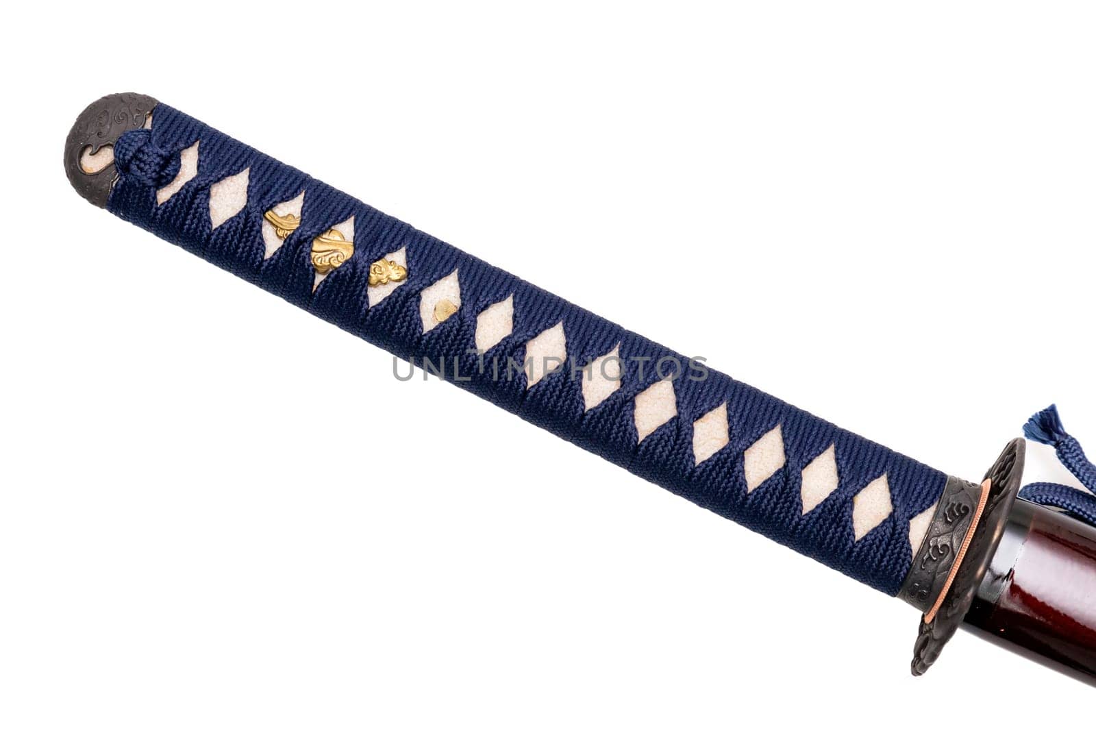 Tsuka : handle of Japanese sword wrapped by navy silk cord on white ray skin isolated in white background. Selective focus.