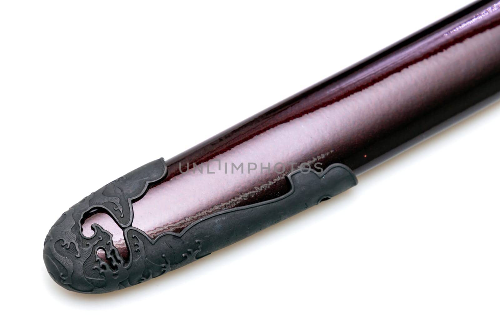 'Kojiri' is the end of the Japanese sword's scabbard or the protective fitting at the end of the scabbard. Normally made by horn but in this picture is metal. Isolated in white Background.
