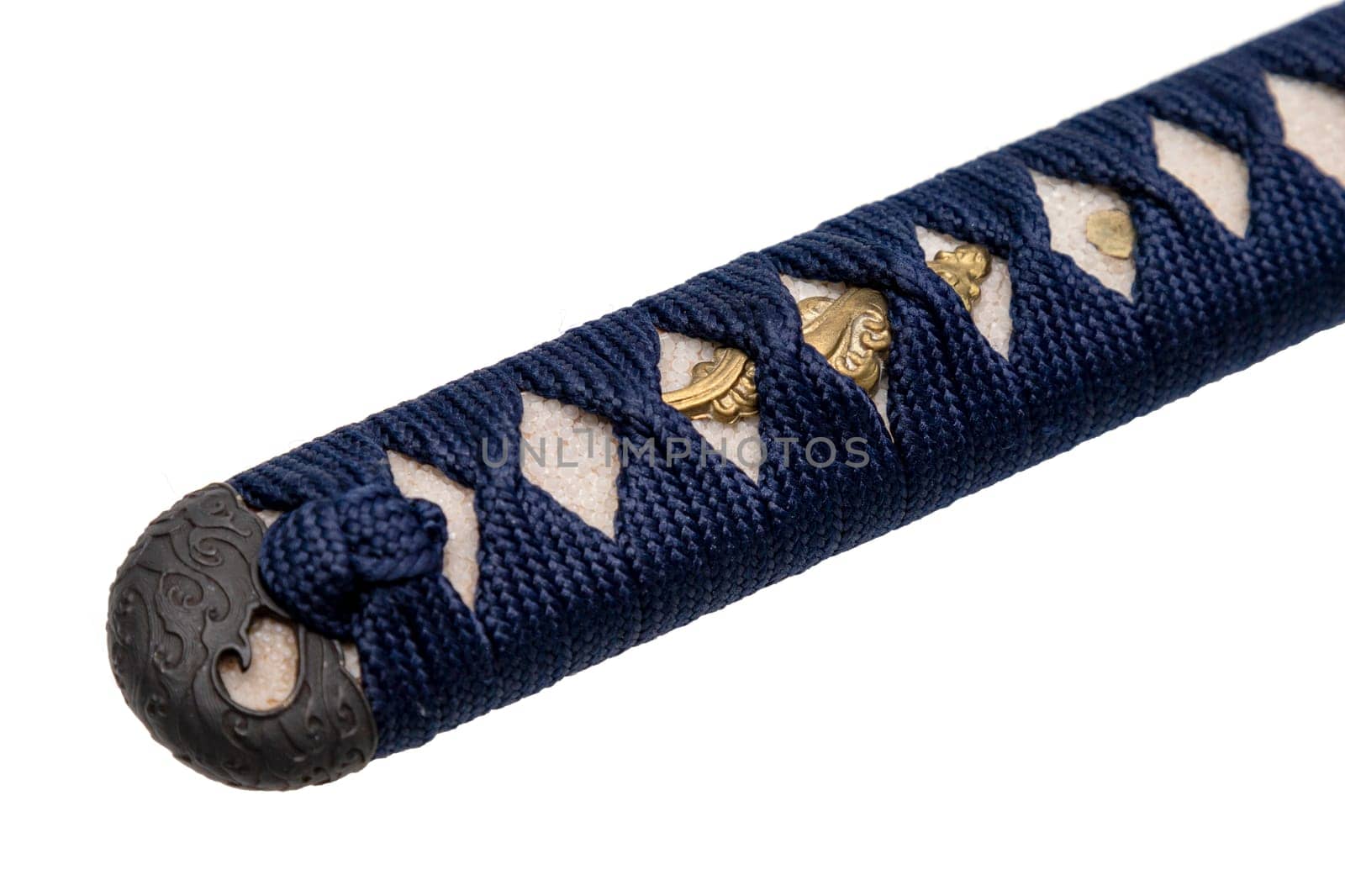 Close-up Tsuka : handle of Japanese sword wrapped by navy blue silk cord with gold fitting isolated in white background. Selective focus.