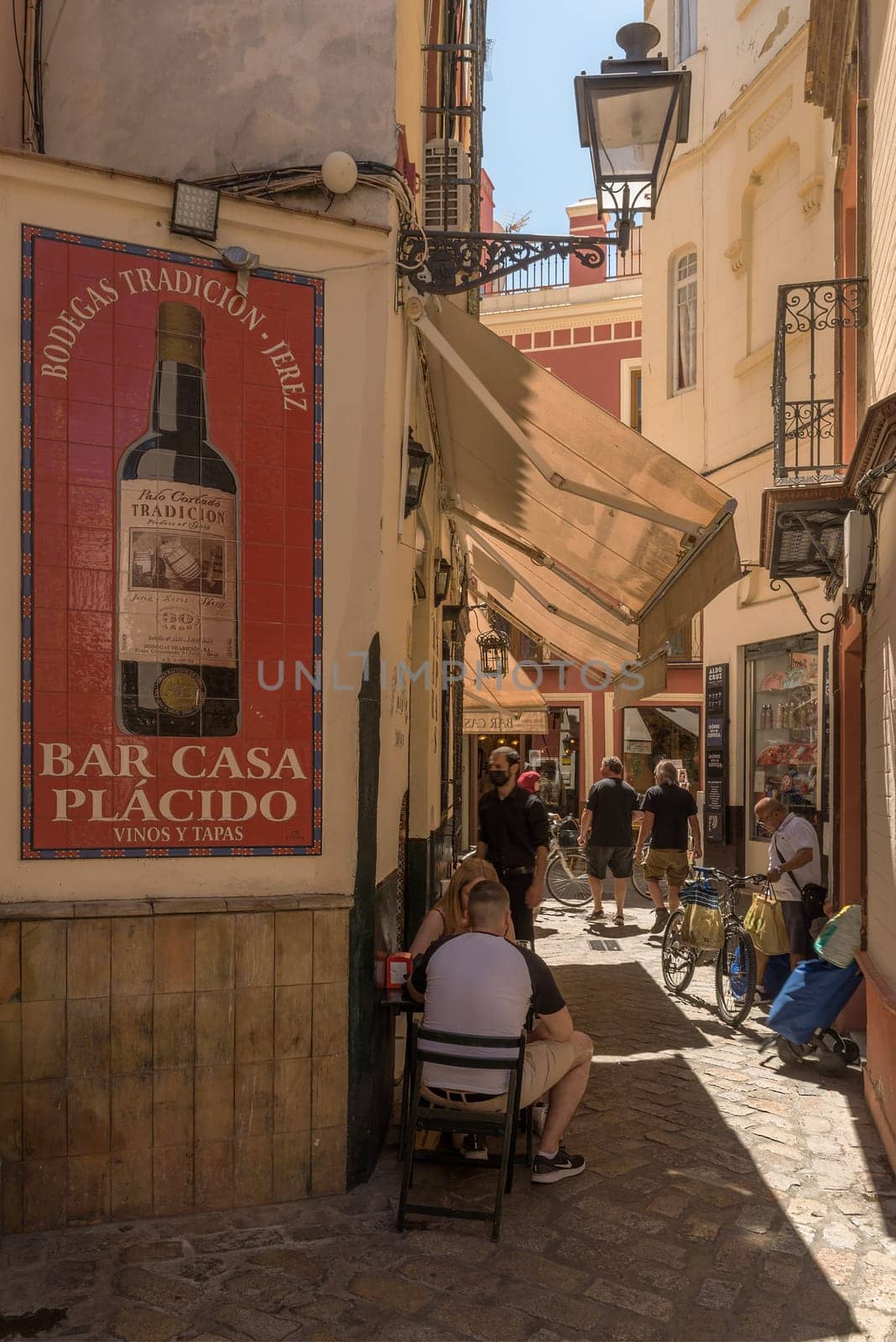 small narrow street in the historic old town of Seville, Spain