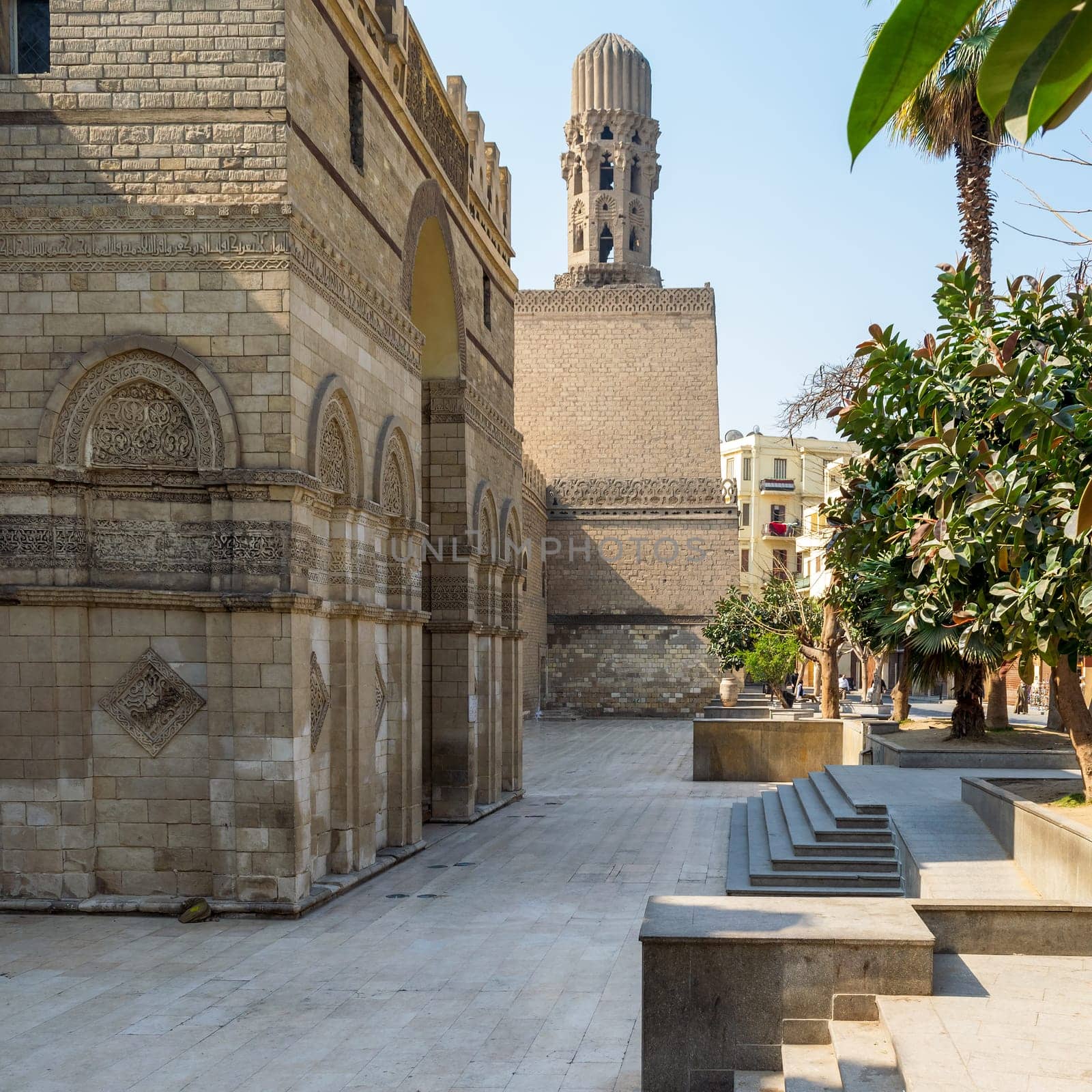 Cairo, Egypt- March 21 2015: Entrance of public historic Al Hakim Mosque known as The Enlightened Mosque with Minaret in the far end, located in Moez Street, Old Cairo