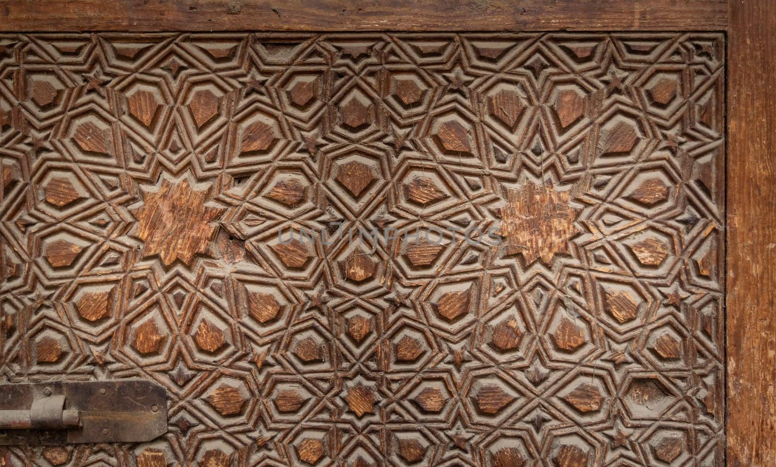 Geometrical engraved decorations of an aged wooden ornate door leaf, Old Cairo, Egypt