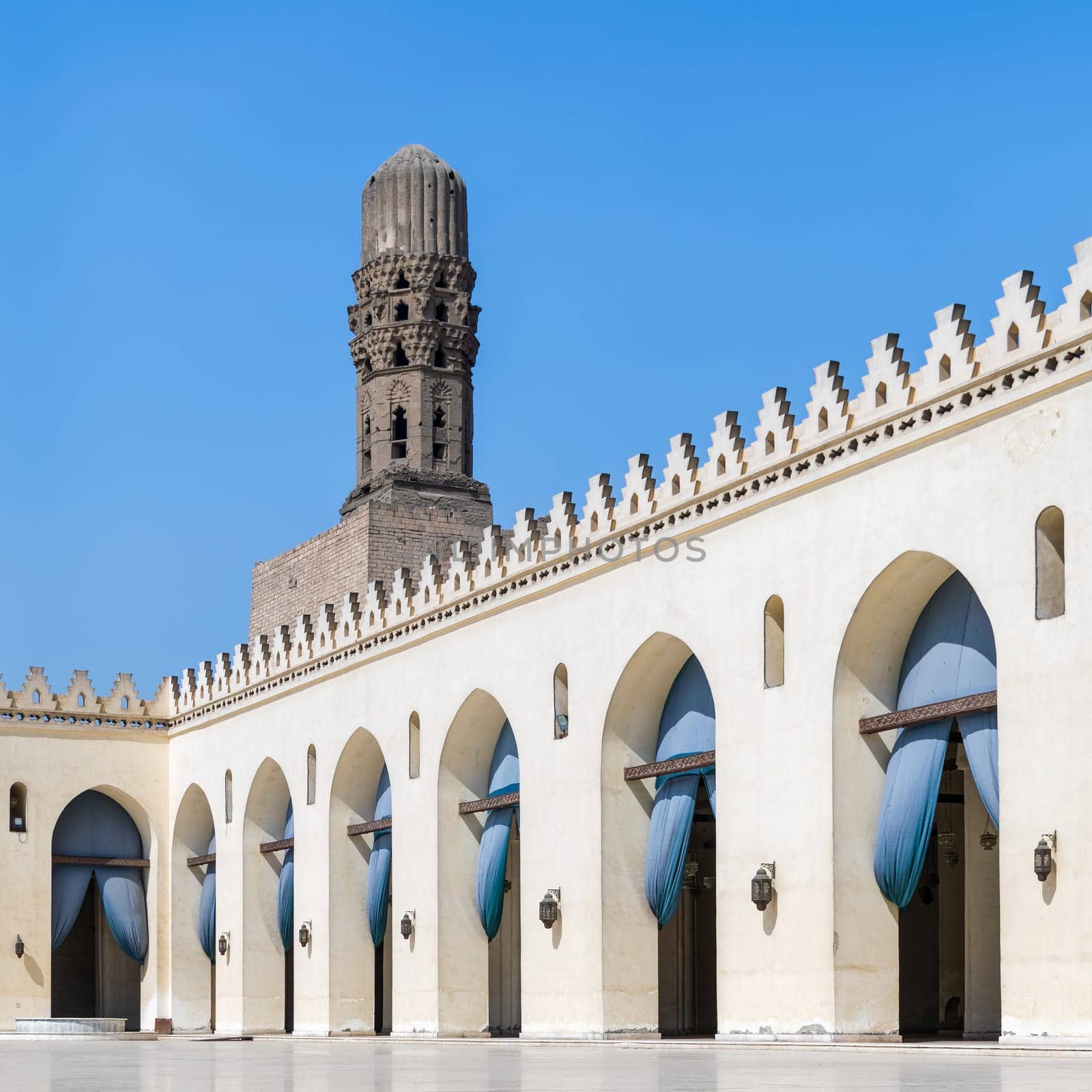 Minaret of public historic Al Hakim Mosque known as The Enlightened Mosque, located in Moez Street, south of the old door of old Cairo gate named Bab Al-Futuh, Egypt