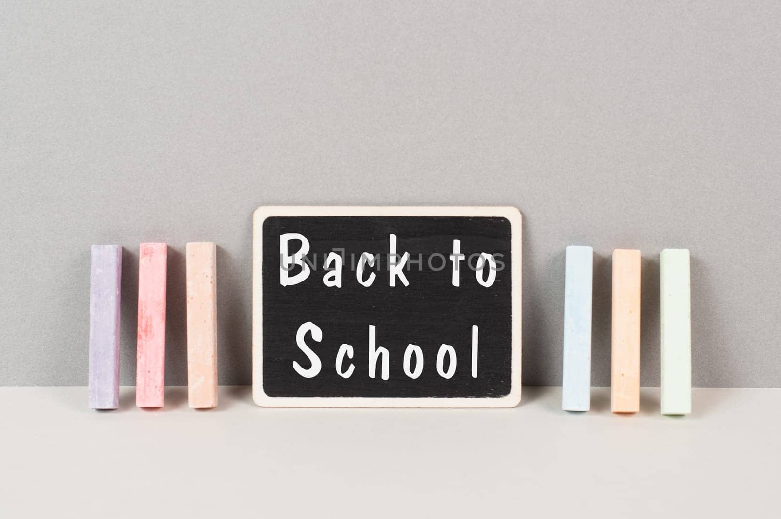 Chalkboard with the text back to school, education concept, colorful chalk
