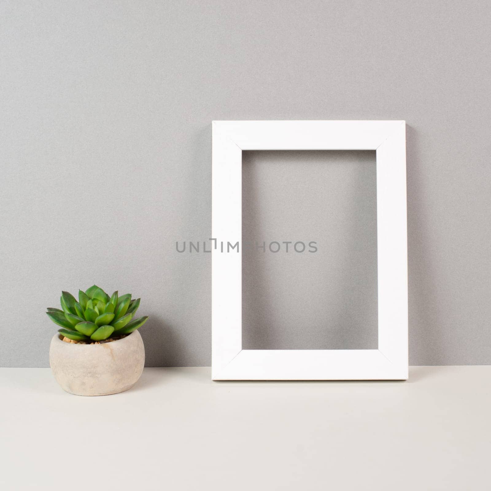Home interior poster mock up with wooden frame, cactus in a pot, colored wall background, copy space for text and pictures