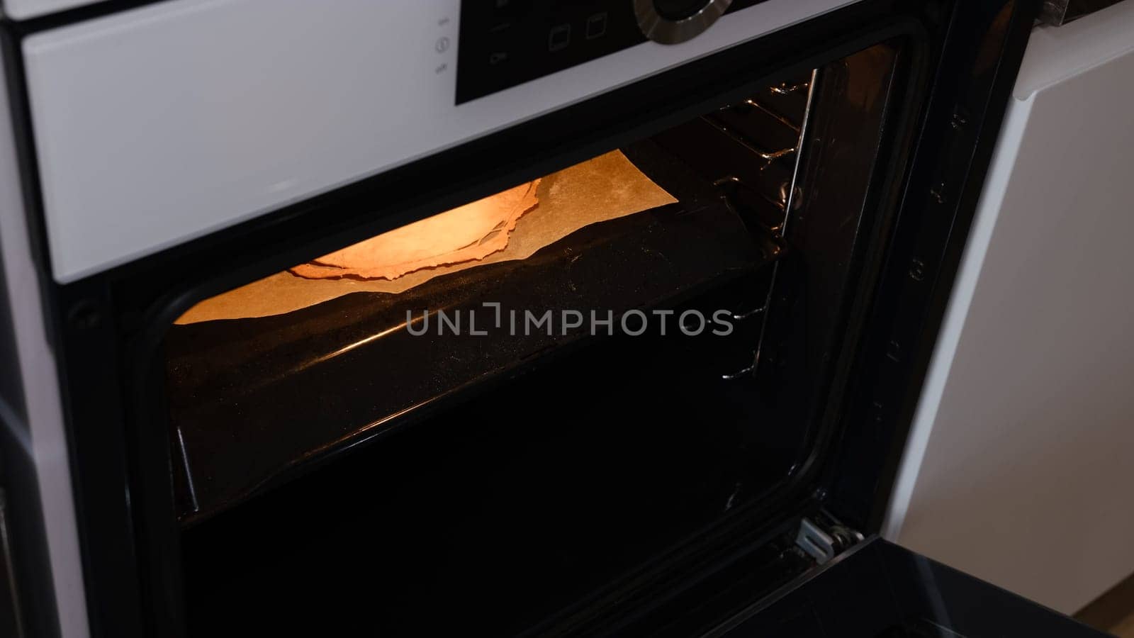 Homemade baked puff layers for napoleon cake taking off from the oven.
