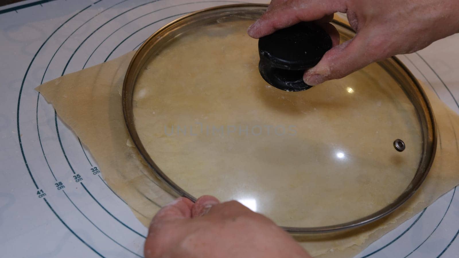 Cutting cookies with a cookie cutter on the size meter board.