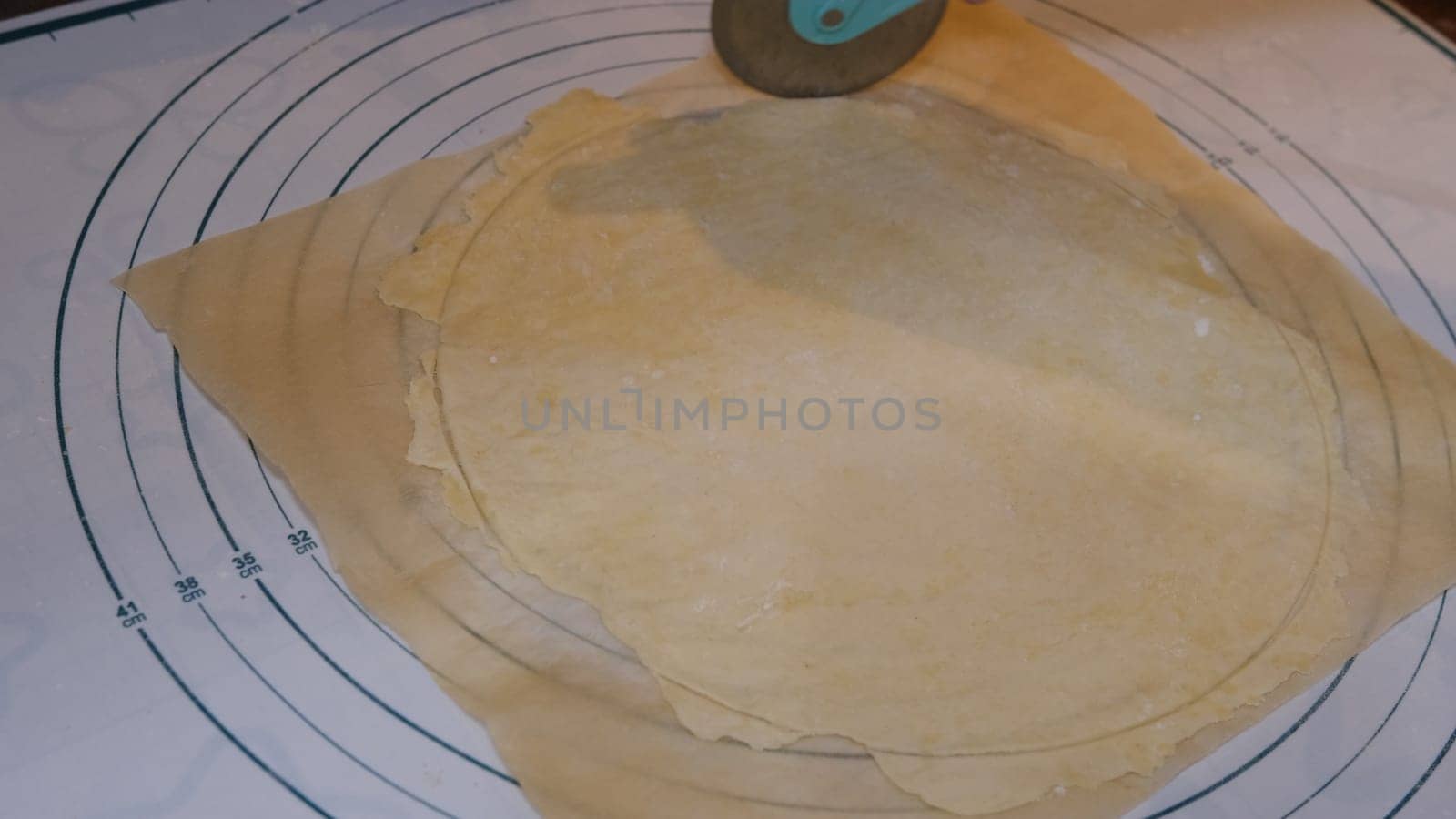 Cutting cookies with a cookie cutter on the size meter board.