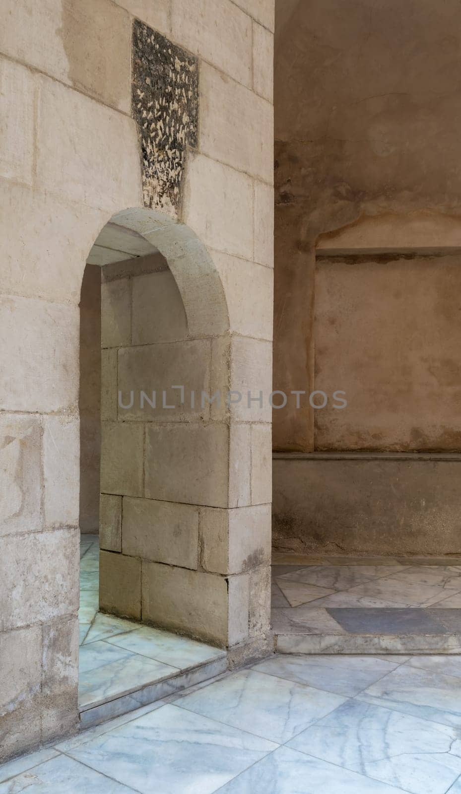 Aged narrow vaulted passage and stone bricks wall, Medieval Cairo, Egypt