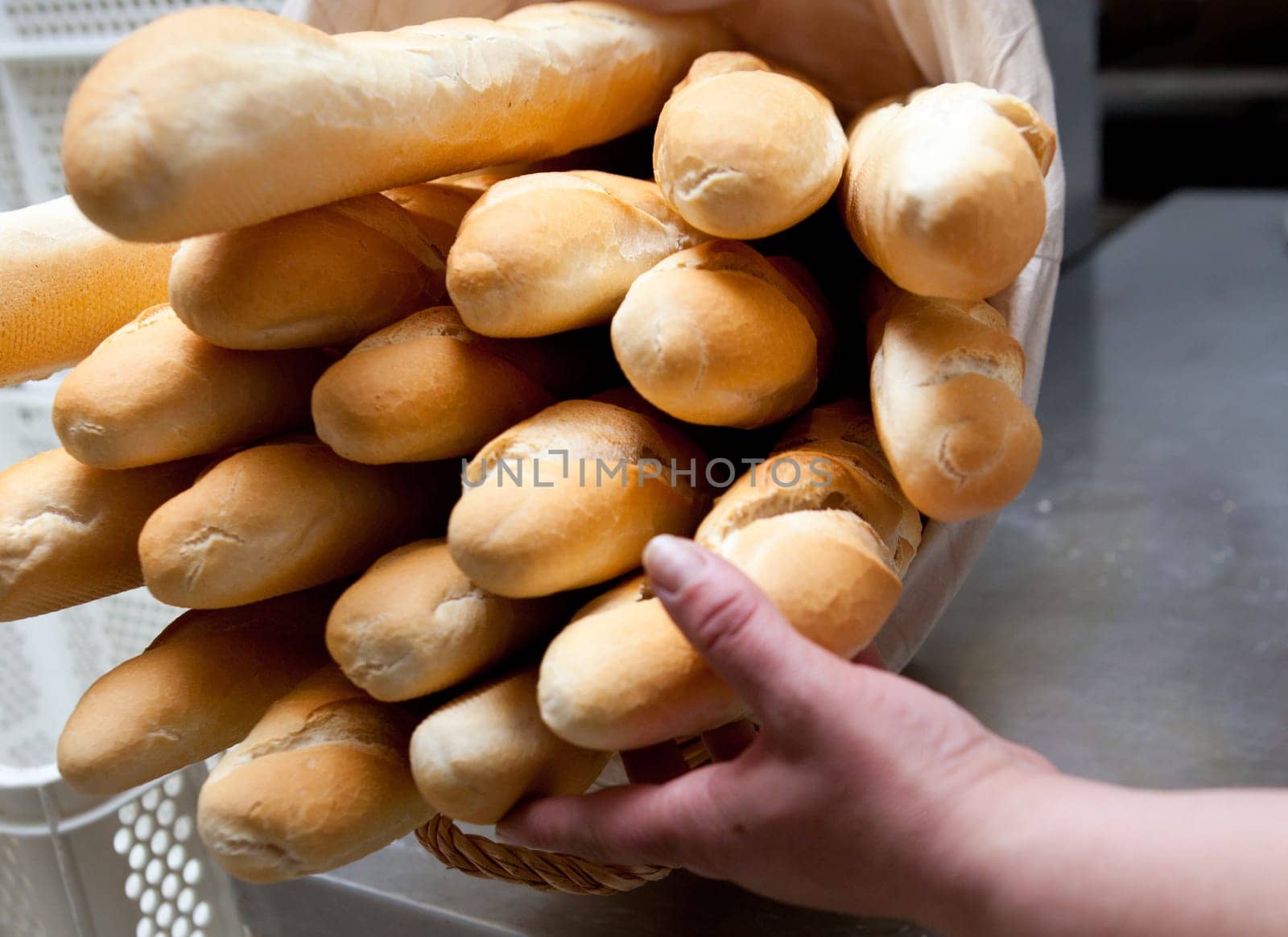 Baguette rows of bread loaves in racks in a bakery