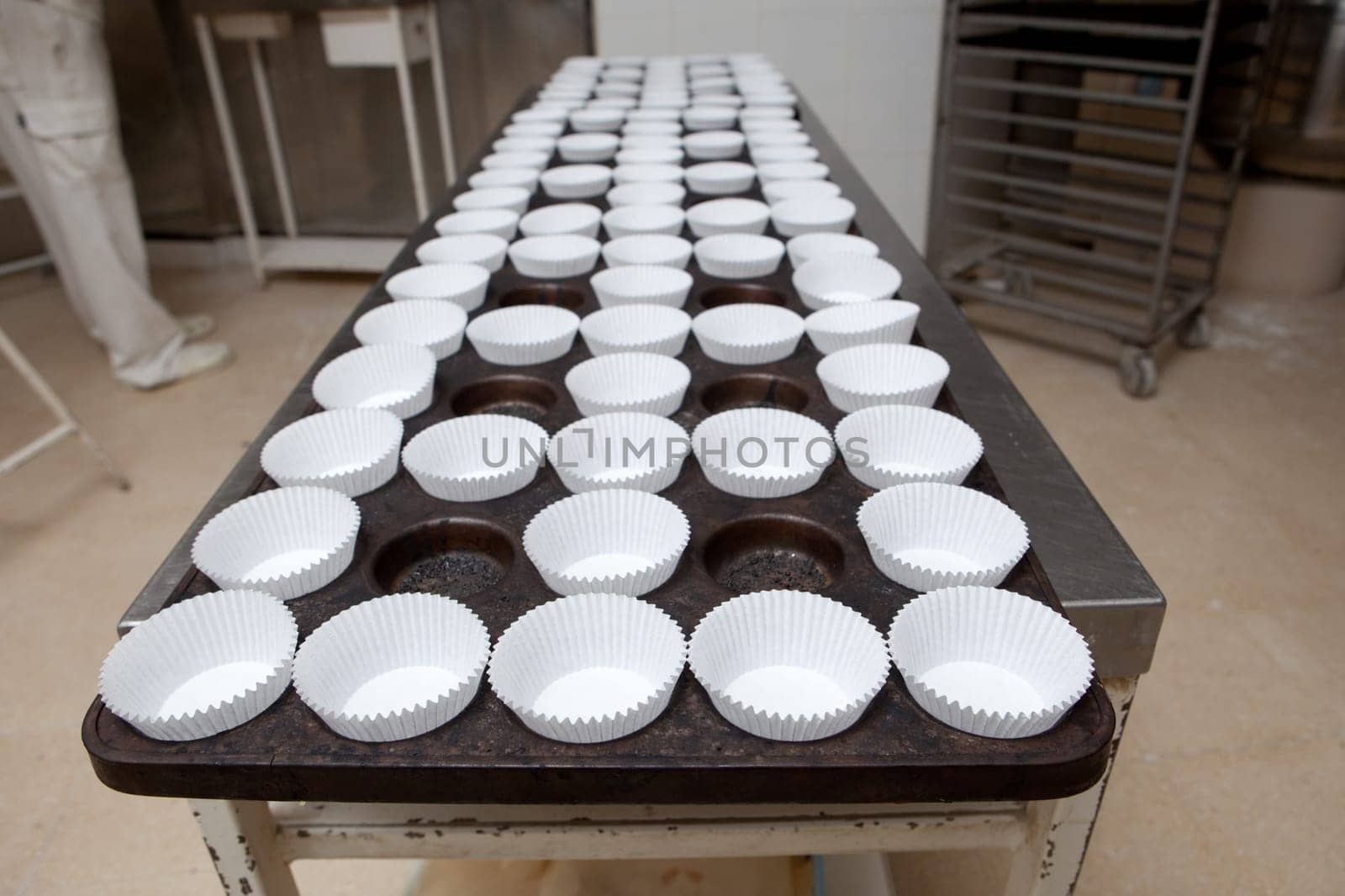 Baking cups tray. Handmade manufacturing process of spanish madeleines