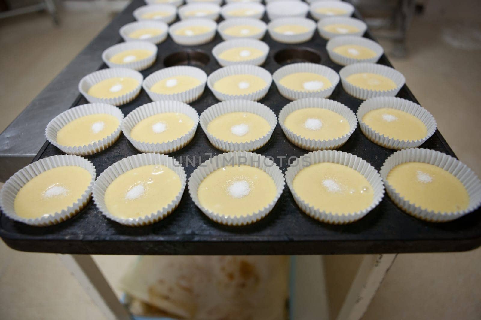 Baking cups tray. Handmade manufacturing process of spanish madeleines