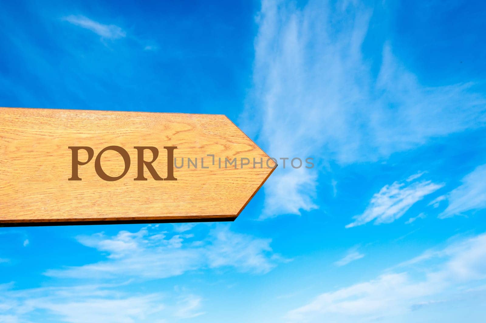 Wooden arrow sign pointing destination PORI, FINLAND against clear blue sky with copy space available. Travel destination conceptual image